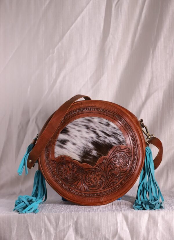 Round Cowhide hand carved leather bag with tassels.